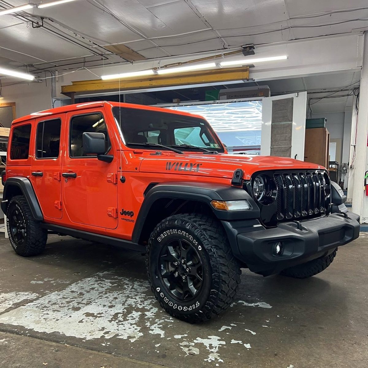 Orange Jeep Wrangler in the shop